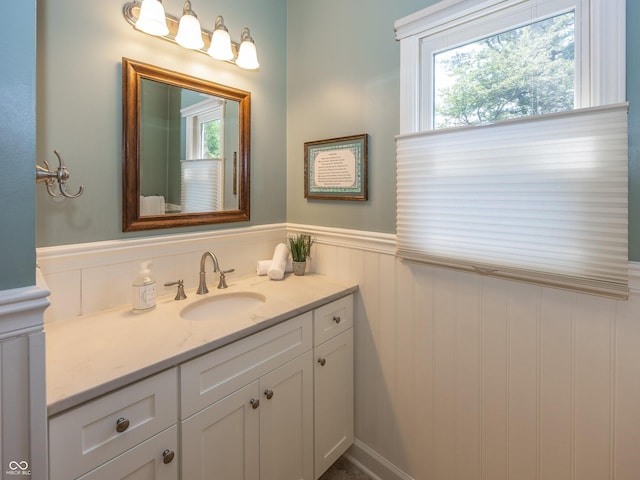 8708 Highwood Ln, Indianapolis, IN 46278 - bathroom featuring a wainscoted wall, vanity, healthy amount of natural light, and a decorative wall