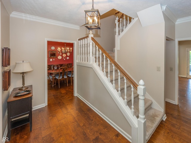 8708 Highwood Ln, Indianapolis, IN 46278 - stairway featuring a chandelier, ornamental molding, and wood finished floors