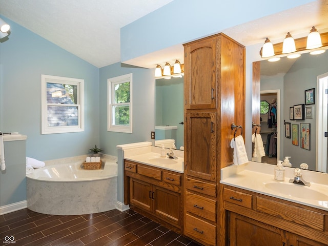 8708 Highwood Ln, Indianapolis, IN 46278 - bathroom with lofted ceiling, double vanity, a garden tub, and wood tiled floors