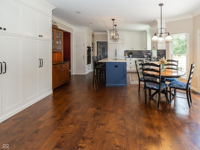 8708 Highwood Ln, Indianapolis, IN 46278 - dining room with a chandelier, dark wood-style floors, and ornamental molding