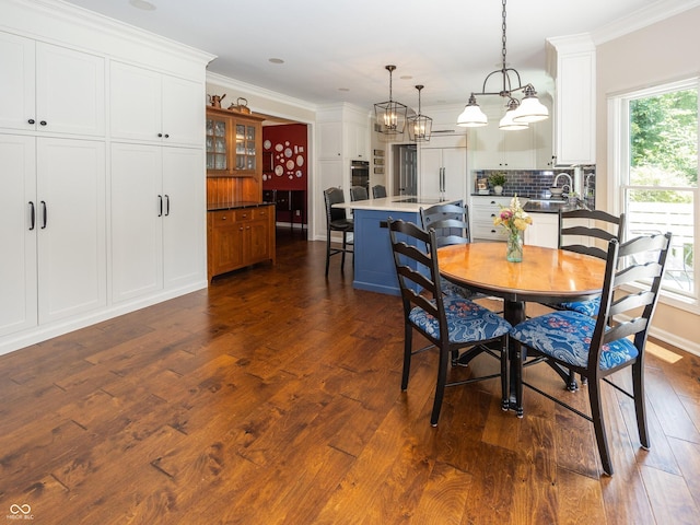 8708 Highwood Ln, Indianapolis, IN 46278 - dining area with ornamental molding, dark wood finished floors, and a chandelier