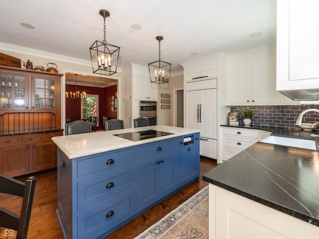 8708 Highwood Ln, Indianapolis, IN 46278 - kitchen featuring black electric cooktop, paneled built in refrigerator, a chandelier, blue cabinets, and a kitchen island