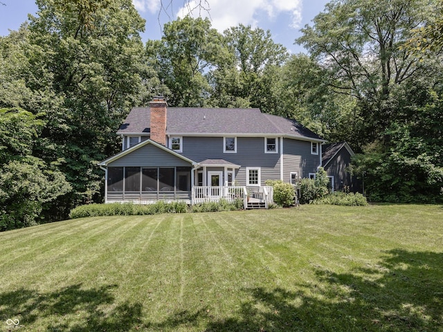 8708 Highwood Ln, Indianapolis, IN 46278 - back of property featuring a sunroom, a chimney, a lawn, and a wooden deck