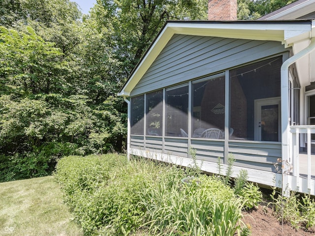 8708 Highwood Ln, Indianapolis, IN 46278 - view of side of property featuring a sunroom and a chimney
