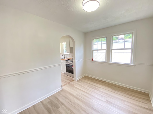 4002 E Pleasant Run Parkway N Drive, Indianapolis, IN 46201 - spare room featuring arched walkways and light wood-type flooring