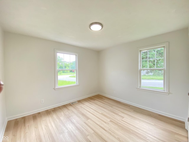 4002 E Pleasant Run Parkway N Drive, Indianapolis, IN 46201 - empty room featuring plenty of natural light and light wood finished floors