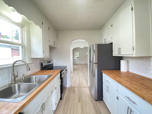 4002 E Pleasant Run Parkway N Drive, Indianapolis, IN 46201 - kitchen featuring stainless steel electric stove, wooden counters, a textured ceiling, light wood-style flooring, and white cabinetry