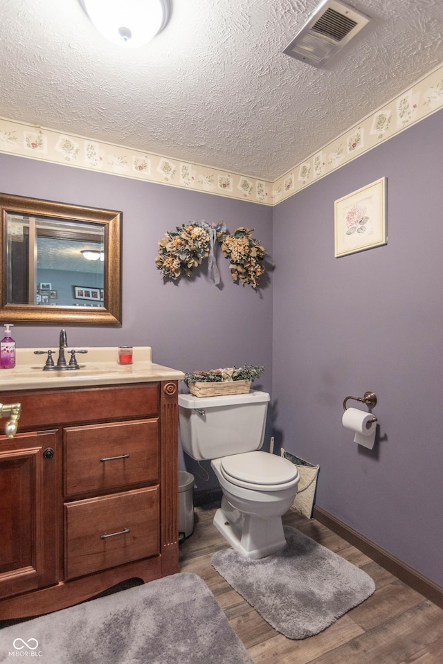 5237 Honey Comb Ln, Indianapolis, IN 46221 - half bathroom featuring a textured ceiling, wood finished floors, and vanity