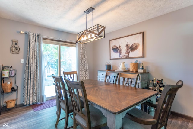 5237 Honey Comb Ln, Indianapolis, IN 46221 - dining room with wood finished floors, a chandelier, and a textured ceiling