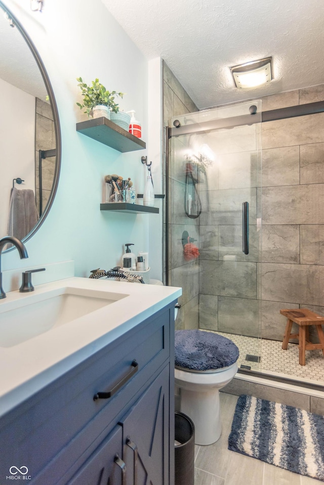 5237 Honey Comb Ln, Indianapolis, IN 46221 - bathroom with vanity, a stall shower, and a textured ceiling