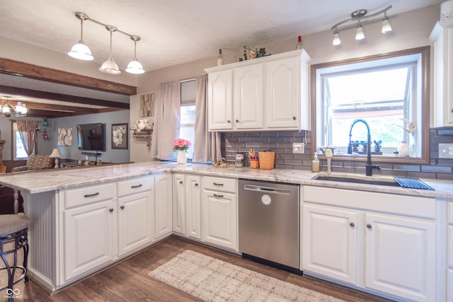 5237 Honey Comb Ln, Indianapolis, IN 46221 - kitchen with dishwasher, a peninsula, healthy amount of natural light, white cabinetry, and beam ceiling