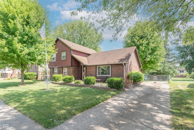 5237 Honey Comb Ln, Indianapolis, IN 46221 - view of front of house featuring brick siding, driveway, a gate, and a shingled roof