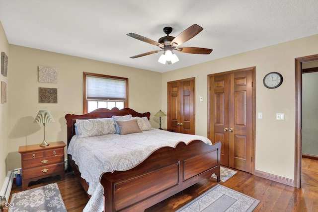 5238 N 225 E, Whiteland, IN 46184 - bedroom with a baseboard heating unit, dark wood finished floors, multiple closets, and ceiling fan