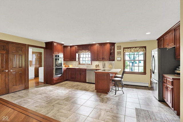 5238 N 225 E, Whiteland, IN 46184 - kitchen with stainless steel appliances, a breakfast bar, light countertops, tasteful backsplash, and recessed lighting