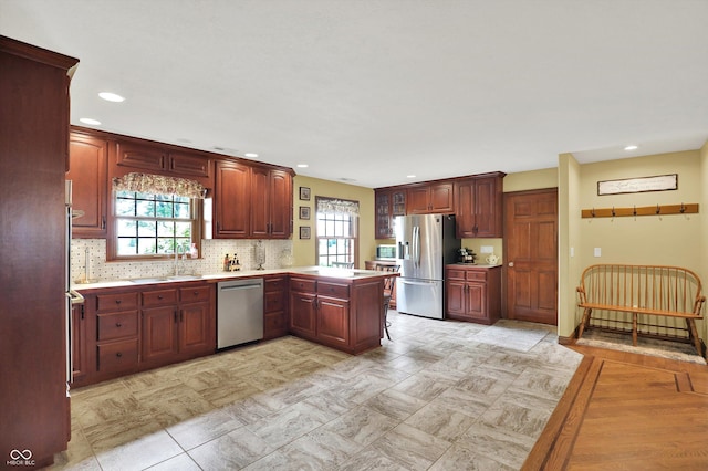 5238 N 225 E, Whiteland, IN 46184 - kitchen with stainless steel appliances, a peninsula, light countertops, backsplash, and recessed lighting