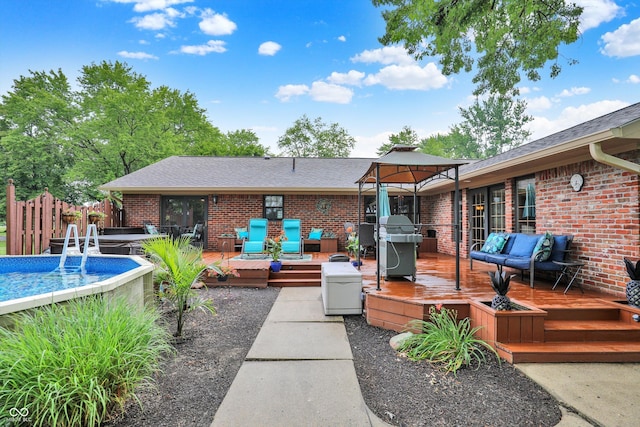 5238 N 225 E, Whiteland, IN 46184 - back of property with a gazebo, a deck, an outdoor pool, brick siding, and a shingled roof