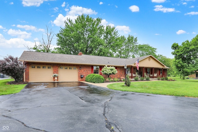 5238 N 225 E, Whiteland, IN 46184 - single story home with an attached garage, brick siding, driveway, and a front lawn
