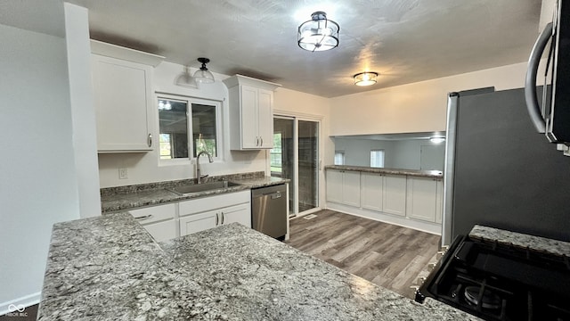 7231 S Franklin Rd, Indianapolis, IN 46259 - kitchen featuring appliances with stainless steel finishes, white cabinets, dark wood-style floors, and dark stone counters