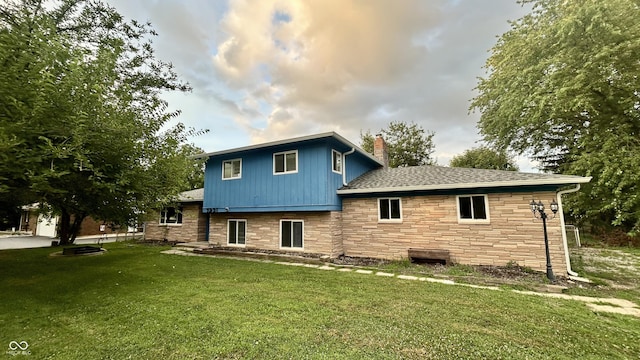 7231 S Franklin Rd, Indianapolis, IN 46259 - rear view of property featuring stone siding, a chimney, and a yard