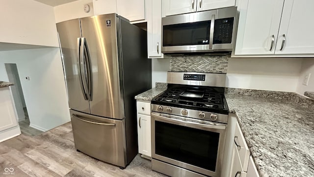 7231 S Franklin Rd, Indianapolis, IN 46259 - kitchen featuring stainless steel appliances, light wood-style flooring, white cabinetry, and light stone countertops