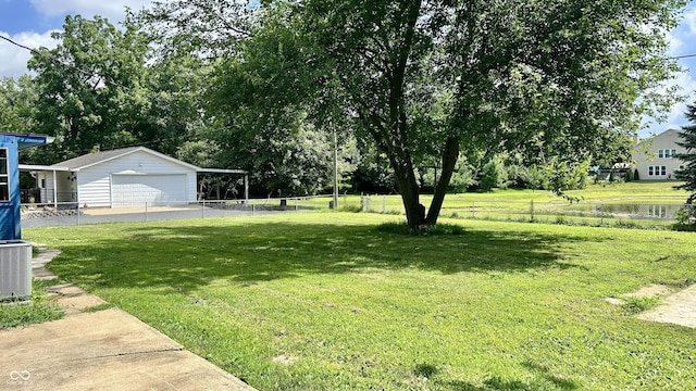 7231 S Franklin Rd, Indianapolis, IN 46259 - view of yard with a garage, an outbuilding, driveway, and view of scattered trees