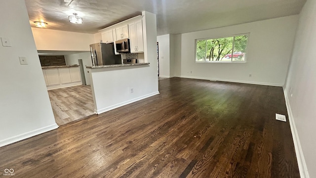 7231 S Franklin Rd, Indianapolis, IN 46259 - kitchen featuring stainless steel appliances, white cabinetry, dark wood-type flooring, open floor plan, and stone countertops