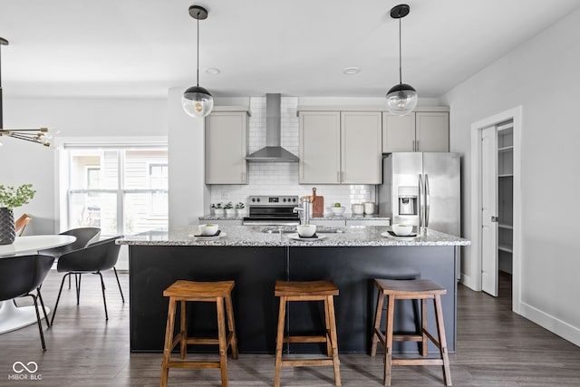 1935 Cornell Ave, Indianapolis, IN 46202 - kitchen featuring wall chimney exhaust hood, tasteful backsplash, an island with sink, range with electric stovetop, and light stone counters