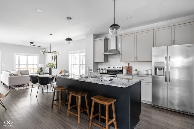 1935 Cornell Ave, Indianapolis, IN 46202 - kitchen with appliances with stainless steel finishes, wall chimney exhaust hood, gray cabinetry, decorative backsplash, and dark wood finished floors