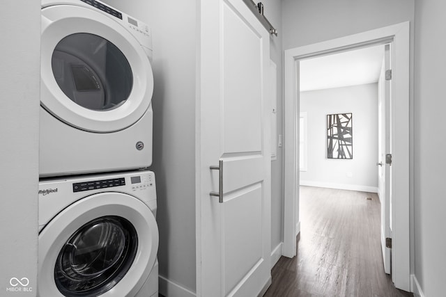 1935 Cornell Ave, Indianapolis, IN 46202 - laundry room featuring stacked washer / dryer, dark wood-type flooring, and a barn door
