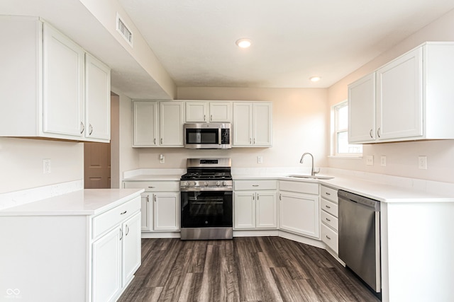 990 Constellation Way, Franklin, IN 46131 - kitchen featuring appliances with stainless steel finishes, white cabinets, dark wood finished floors, light countertops, and recessed lighting