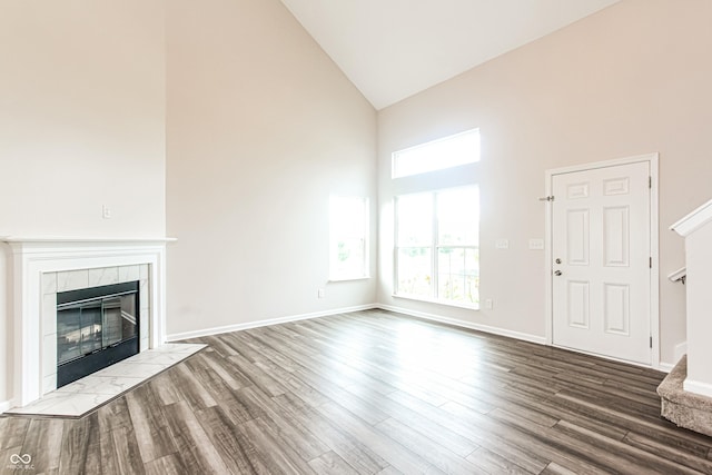 990 Constellation Way, Franklin, IN 46131 - unfurnished living room with high vaulted ceiling, a tiled fireplace, and wood finished floors