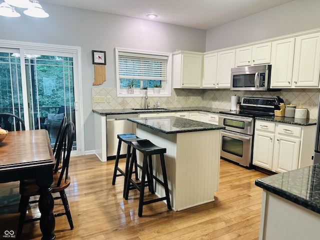 9975 Woodstock Way, Fishers, IN 46037 - kitchen with stainless steel appliances, light wood-style floors, white cabinets, and recessed lighting