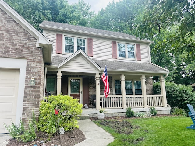 9975 Woodstock Way, Fishers, IN 46037 - view of front facade featuring a porch, brick siding, a front lawn, and a shingled roof