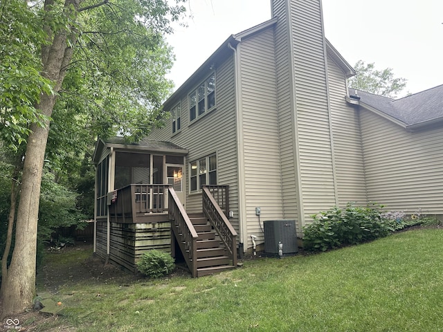 9975 Woodstock Way, Fishers, IN 46037 - rear view of house featuring a sunroom, stairway, a chimney, a yard, and a deck