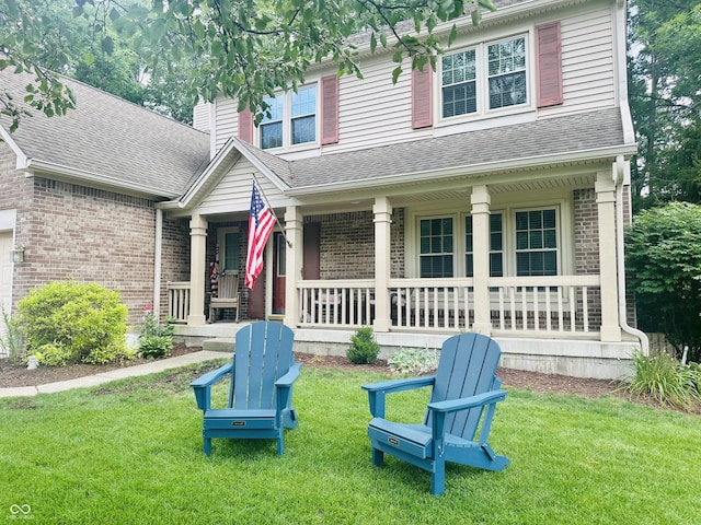 9975 Woodstock Way, Fishers, IN 46037 - view of front facade featuring a porch, brick siding, and a front yard