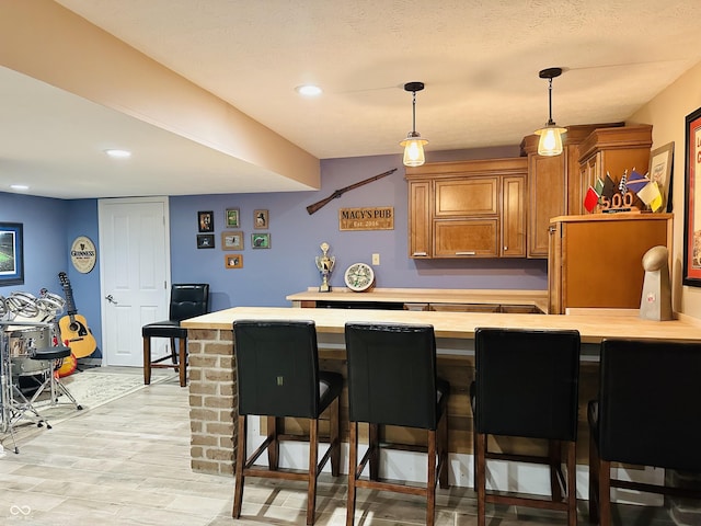 9975 Woodstock Way, Fishers, IN 46037 - bar featuring hanging light fixtures, light wood finished floors, and recessed lighting