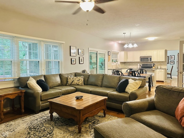 9975 Woodstock Way, Fishers, IN 46037 - living area featuring ceiling fan, light wood-type flooring, and a chandelier