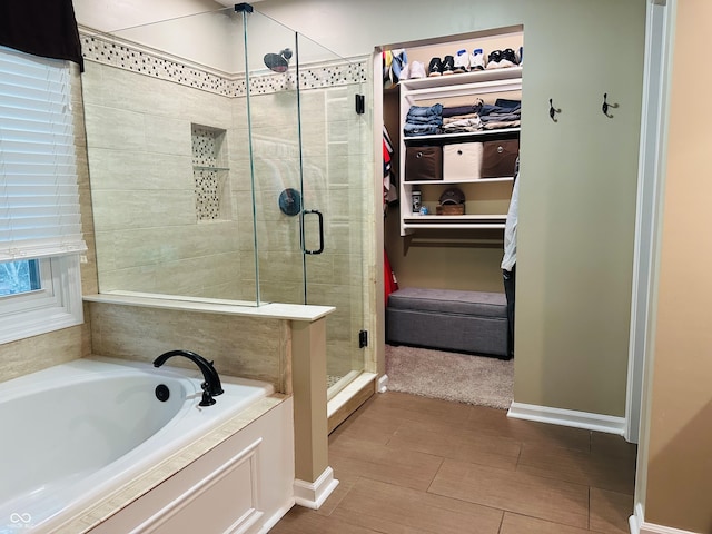 9975 Woodstock Way, Fishers, IN 46037 - bathroom featuring a shower stall, a garden tub, and a spacious closet