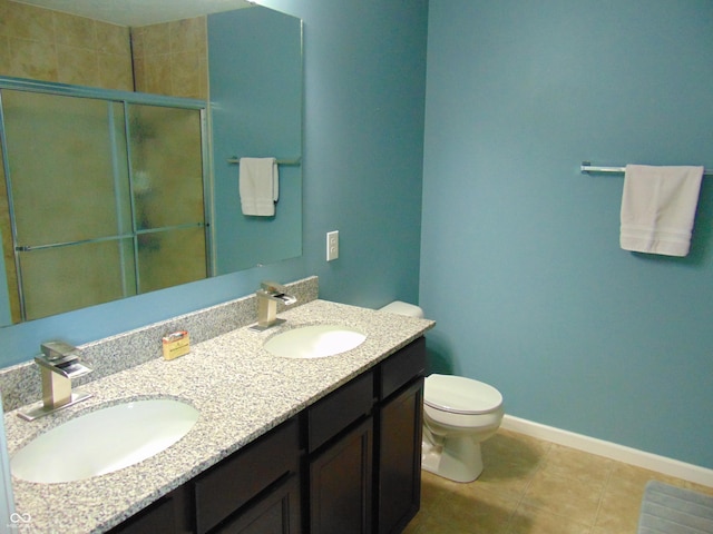 2703 Night Hawk Rd, Greenwood, IN 46143 - bathroom featuring double vanity, tile patterned flooring, and an enclosed shower