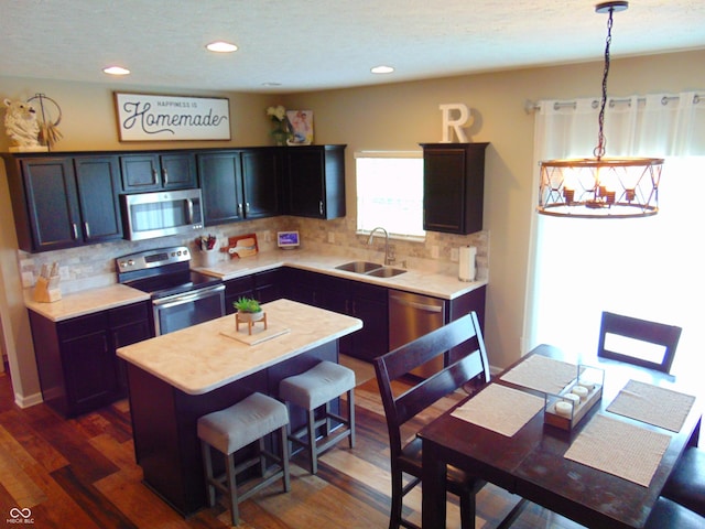 2703 Night Hawk Rd, Greenwood, IN 46143 - kitchen with appliances with stainless steel finishes, light countertops, a center island, backsplash, and recessed lighting