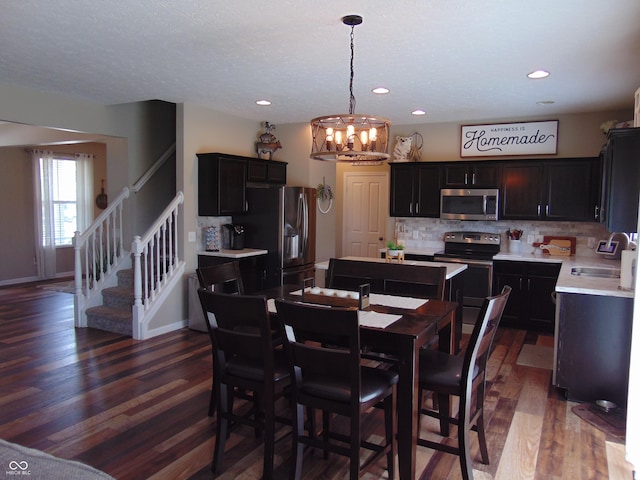 2703 Night Hawk Rd, Greenwood, IN 46143 - dining area featuring a chandelier, stairs, dark wood finished floors, and recessed lighting