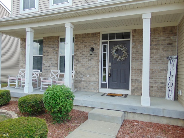 2703 Night Hawk Rd, Greenwood, IN 46143 - view of exterior entry featuring a porch and brick siding