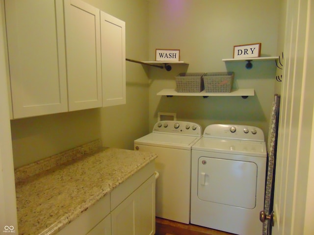 2703 Night Hawk Rd, Greenwood, IN 46143 - laundry room featuring washer and dryer, cabinet space, and dark wood-style floors