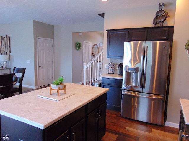 2703 Night Hawk Rd, Greenwood, IN 46143 - kitchen featuring stainless steel fridge, light countertops, dark wood-style floors, a kitchen island, and dark brown cabinetry