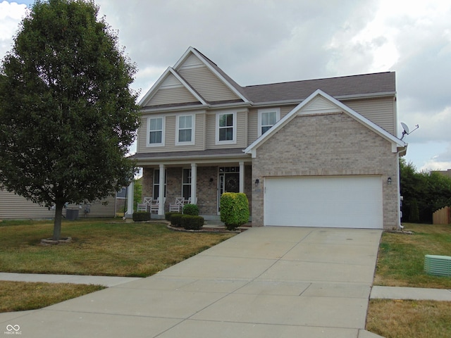 2703 Night Hawk Rd, Greenwood, IN 46143 - view of front facade with covered porch, an attached garage, a front lawn, driveway, and brick siding