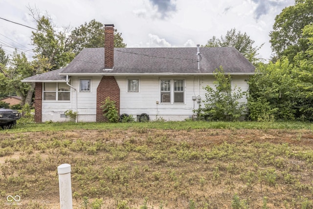 913 S Hall St, Princeton, IN 47670 - view of side of property featuring a chimney and roof with shingles