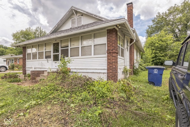 913 S Hall St, Princeton, IN 47670 - view of side of property with a chimney, a shingled roof, and brick siding