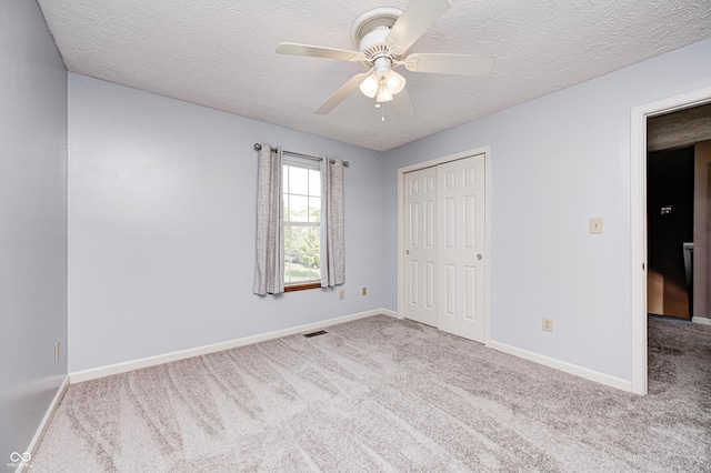 1143 Kinross Dr, Avon, IN 46123 - unfurnished bedroom with carpet flooring, a textured ceiling, a closet, and ceiling fan
