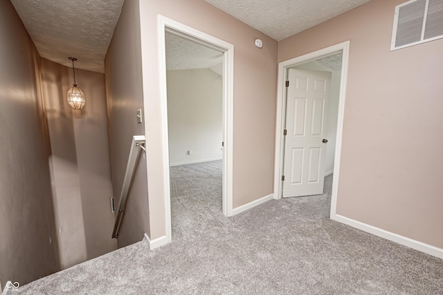 1143 Kinross Dr, Avon, IN 46123 - hallway with a textured ceiling, an upstairs landing, and carpet flooring
