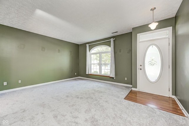 1143 Kinross Dr, Avon, IN 46123 - carpeted entrance foyer featuring baseboards and a textured ceiling